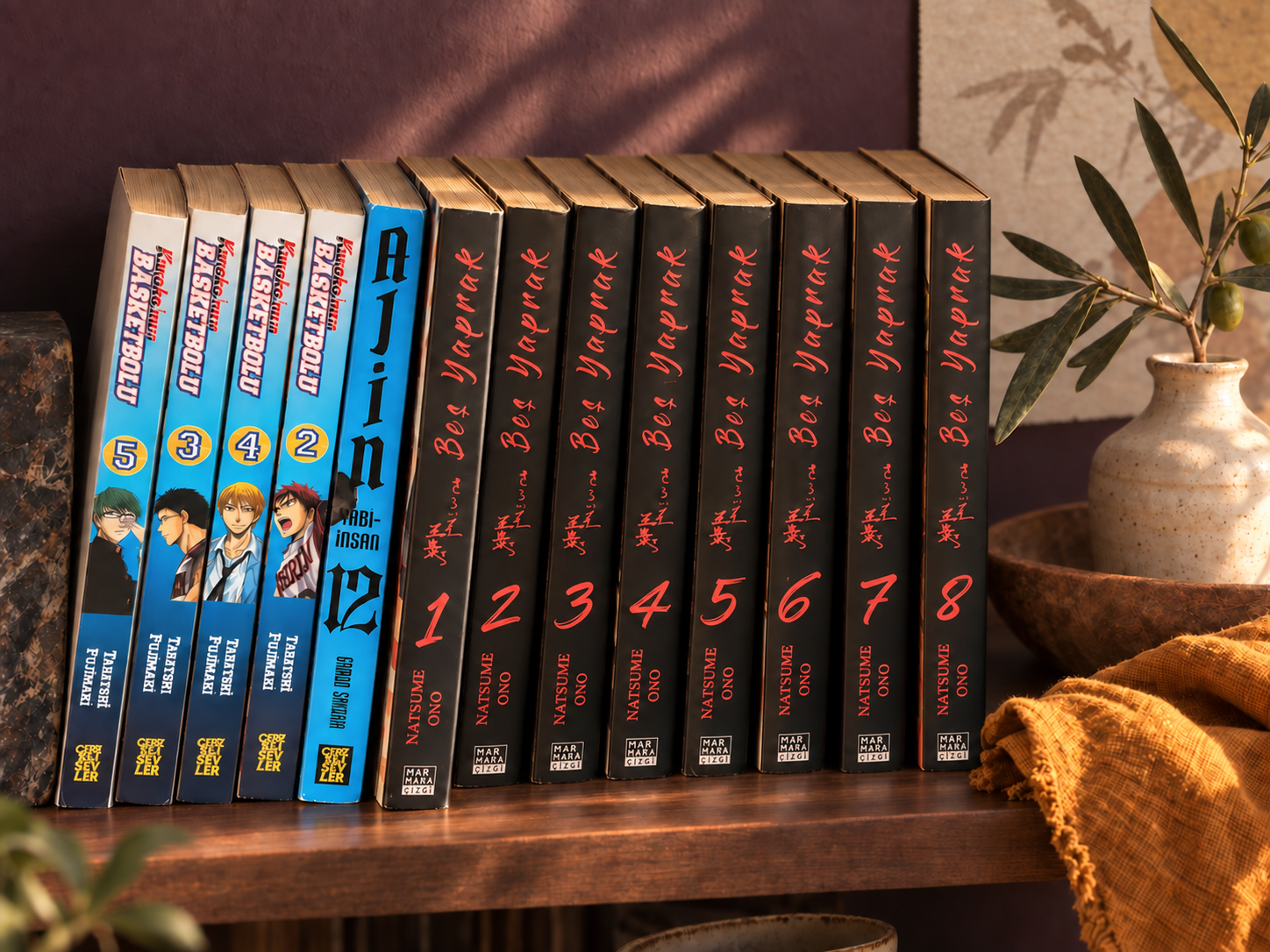 Turkish editions of Kuroko’s Basketball, Ajin and the complete eight-volume Five Leaves set in a warm reading corner